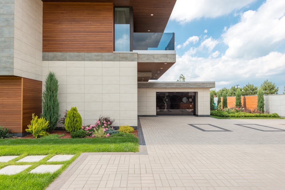 Block paved driveway in front of a modern home